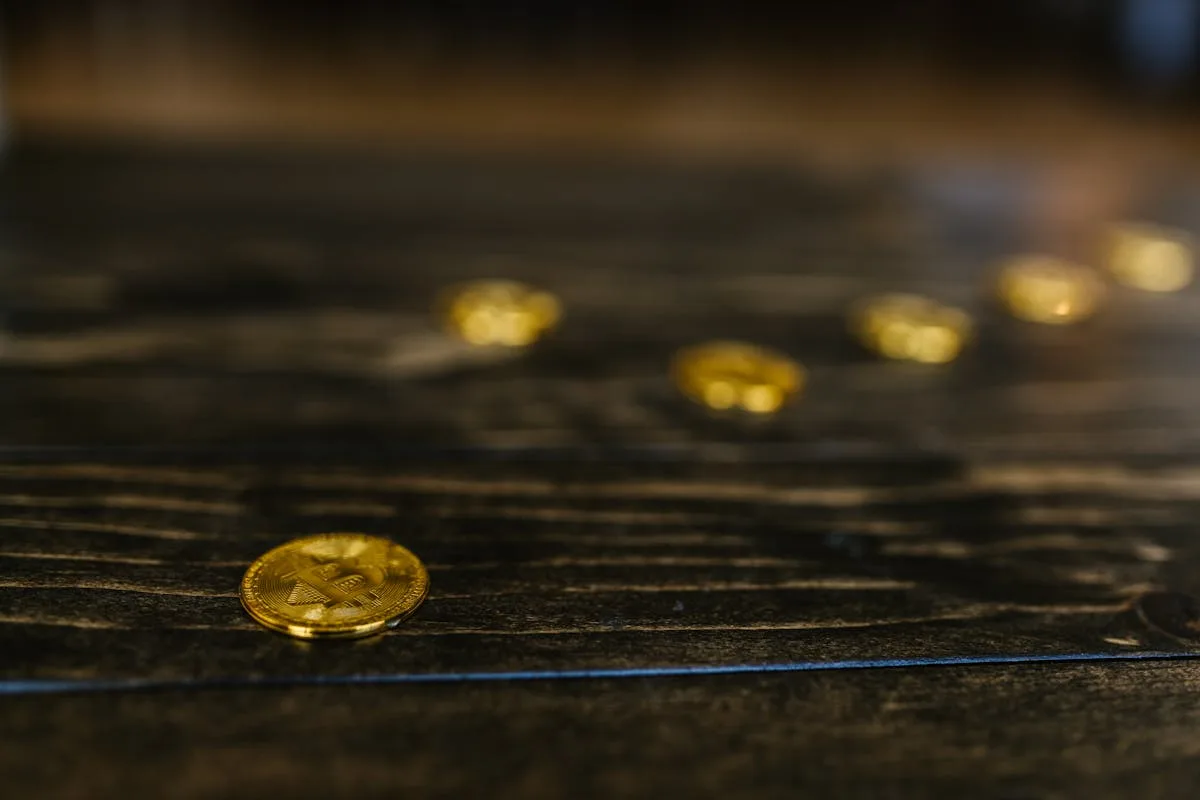 Collection NFT các loại - Bitcoin coins trải trên bề mặt gỗ tối