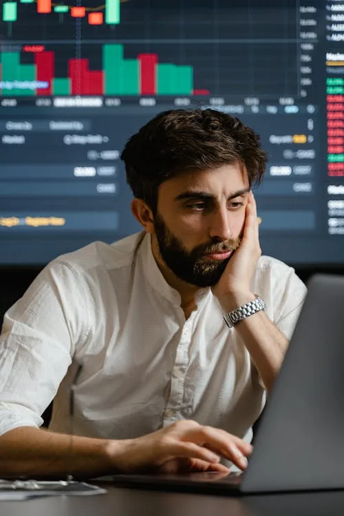Man looking at crypto trading chart - NFT floor price marketplace value
